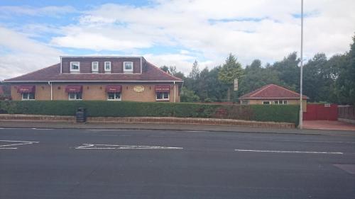 a house on the side of a street at Glenfern Guest House and a separate Cottage with its own private hot tub in Balloch