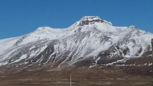 a mountain covered in snow on a clear day at Salthús Guesthouse in Skagaströnd