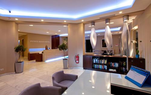 a lobby of a hospital with a reception desk and chairs at Pefkos Beach Studios & Apartments in Pefki Rhodes