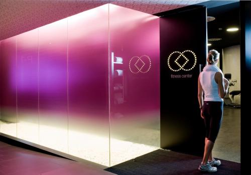 a woman is standing in front of a glass wall at Barceló Raval in Barcelona