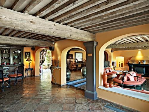 a large room with a stone wall and a fire place at Hôtel Villa Marie Saint Tropez in Saint-Tropez