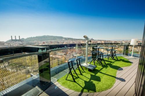 a view from the balcony of a building with tables and chairs at Barceló Raval in Barcelona