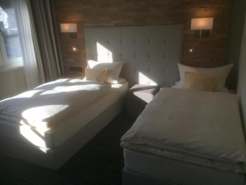 two beds sitting next to a window in a room at Landgasthof Kleiner in Sundern
