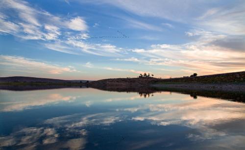 a reflection of the sky in a body of water at Ramathra Fort in Sapotra