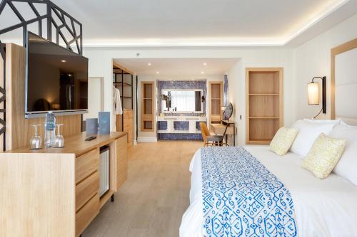 a hotel room with a bed and a television at Gran Tacande Wellness & Relax Costa Adeje in Adeje