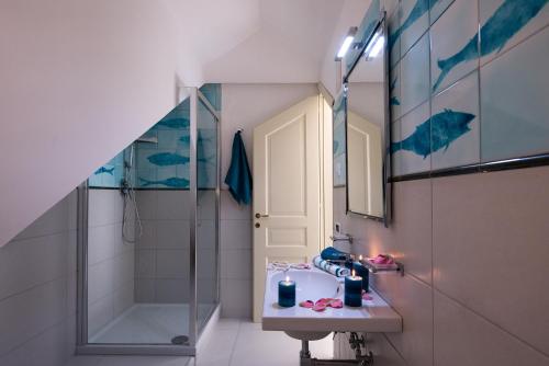 a bathroom with a sink and a shower at Fruit Flats by AMALFIVACATION in Minori