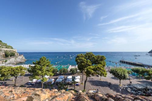 a view of a beach with trees and the ocean at Fruit Flats by AMALFIVACATION in Minori