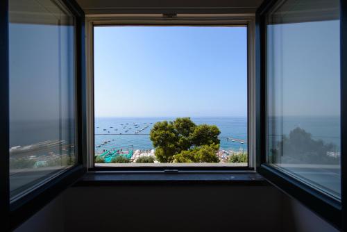 a window with a view of the ocean at Fruit Flats by AMALFIVACATION in Minori
