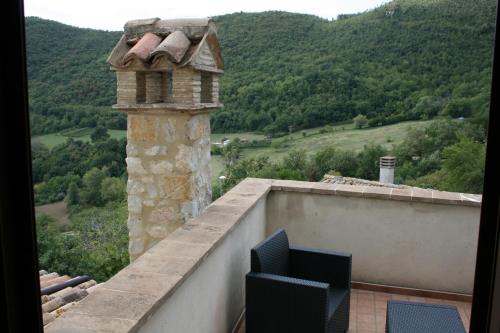 a chimney on top of a building with a view of a mountain at Valle del Belvedere in Spoleto