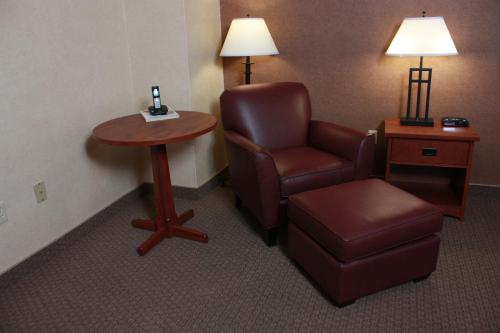 a room with a chair and a table and a stool at Maritime Inn Antigonish in Antigonish