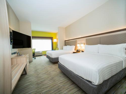 a hotel room with two beds and a flat screen tv at Holiday Inn Express & Suites - Southaven Central - Memphis, an IHG Hotel in Southaven