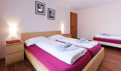 a bedroom with two beds with white sheets at Haus Angelika in Vandans