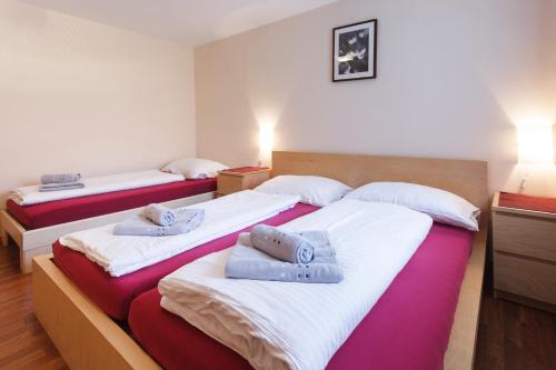 two beds in a hotel room with towels on them at Haus Angelika in Vandans