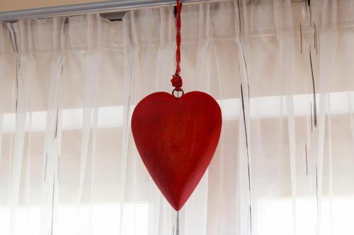 a red heart hanging from a window at Haus Angelika in Vandans