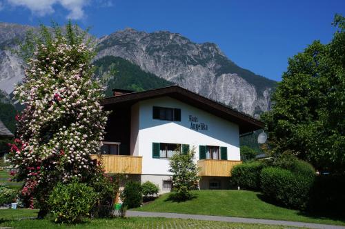a white house with a mountain in the background at Haus Angelika in Vandans