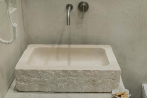 a white bath tub with a faucet in a bathroom at BORGOBELTRANI in Trani