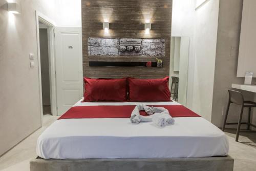 a bedroom with a large bed with red pillows at BORGOBELTRANI in Trani
