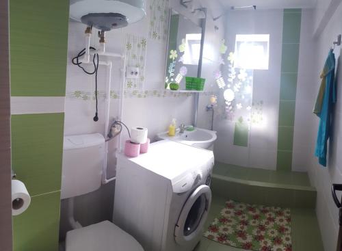 a bathroom with a white toilet and a sink at Apartament Lupu - Eforie Nord in Eforie Nord