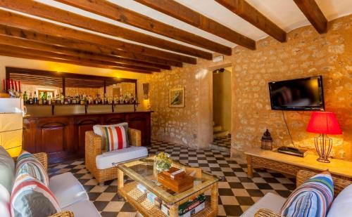 a living room with a couch and a bar at The Salvia - Adults Only in Sóller