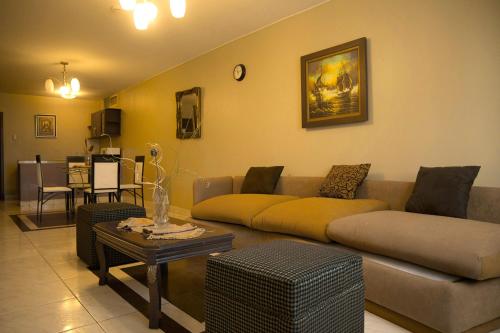 a living room with a couch and a table at Tropical Inn Hotel in Guayaquil