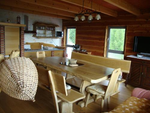 a kitchen with a large wooden table and chairs at Apartments Za Grapo in Cerkno