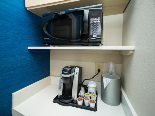 a coffee maker and a microwave on a shelf at Holiday Inn Express & Suites - Southaven Central - Memphis, an IHG Hotel in Southaven