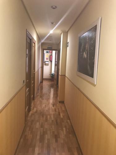 a hallway of a hospital with a painting on the wall at Pension Logroño in Logroño