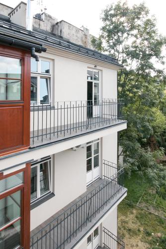 a white building with balconies on the side of it at Aparthotel BC 29 Residence in Kraków