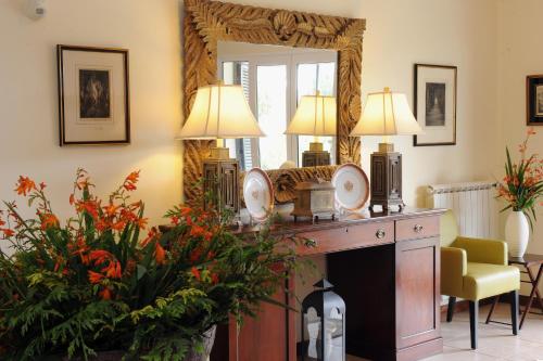 a living room with a mirror and a fireplace at Quinta Da Cova Do Milho in Santo António da Serra