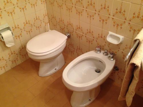 a bathroom with a toilet and a bidet at Mountain Charming Studio in Madesimo