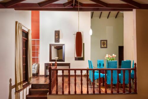 a dining room with blue chairs and a table at Villa Lemon Court in Nuwara Eliya