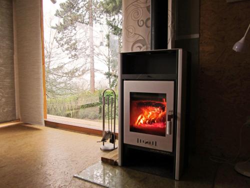 a stove in a room with a fire in it at Vacation Home Pani haje in Moravany