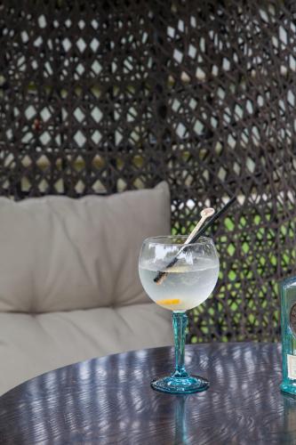a glass with a spoon in it sitting on a table at The Wychwood Inn in Shipton under Wychwood