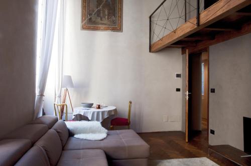 a living room with a brown couch and a table at Charming Genova | Residenza d'epoca in Genova