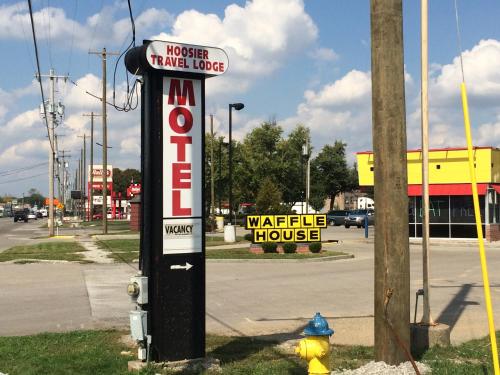 a sign for a waffle house next to a fire hydrant at Hoosier Travel Lodge in Jeffersonville
