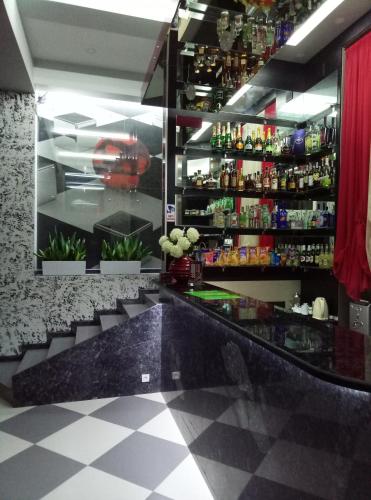 a bar with a black counter and some drinks at Guest house Khan in Kharkiv