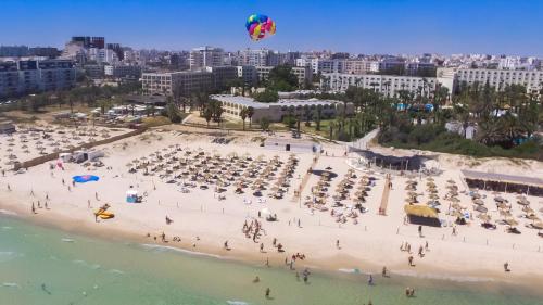 a beach with a kite flying over the ocean at Occidental Sousse Marhaba in Sousse