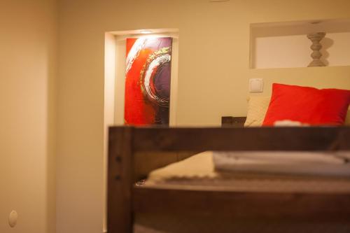 a bedroom with a mirror and a bed with a red pillow at Beja Hostel in Beja