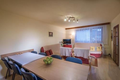 a room with a table and chairs and a dining room at Mária Kičáková TATRY MKS in Štrba