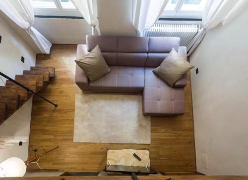 a brown leather couch sitting in the middle of a living room at Charming Genova | Residenza d'epoca in Genova