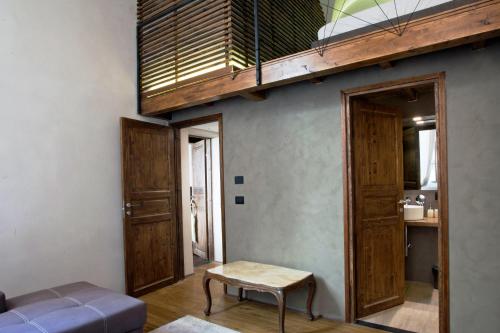 a living room with a staircase and a table at Charming Genova | Residenza d'epoca in Genova