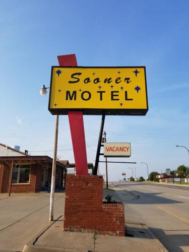 a sign for a camera motel on the side of a street at Sooner Motel in Stroud