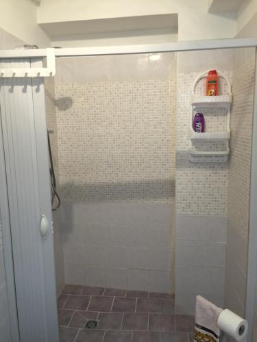a shower with a glass door in a bathroom at Da Santina in Scilla