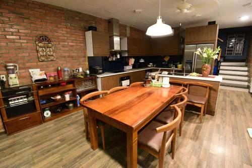 a large kitchen with a wooden table and chairs at Kiara's Home in Hai Phong