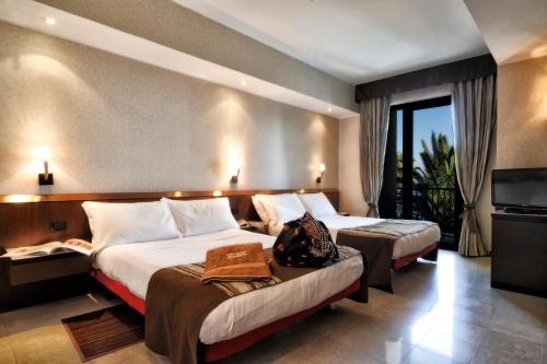 Llit o llits en una habitació de Mare Hotel
