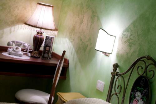 a bedroom with a bed with a lamp on a table at La Portella in Fabriano
