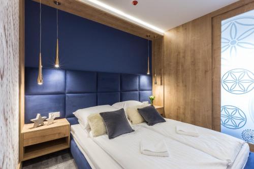 Postel nebo postele na pokoji v ubytování Aparthotel Góralski Spa & Restaurant