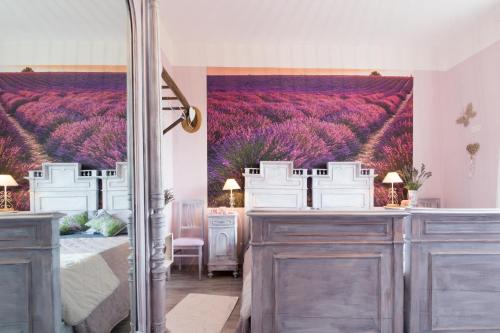 a bedroom with a bed and a window with purple flowers at B&B Cà dal Busc in Sostegno