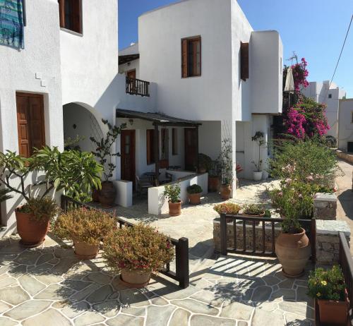 a courtyard of a house with potted plants at Antheia in Chora Folegandros