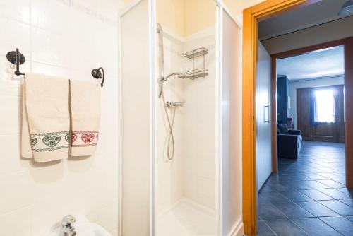a bathroom with a shower and a glass door at Casa Albinelli in Cutigliano